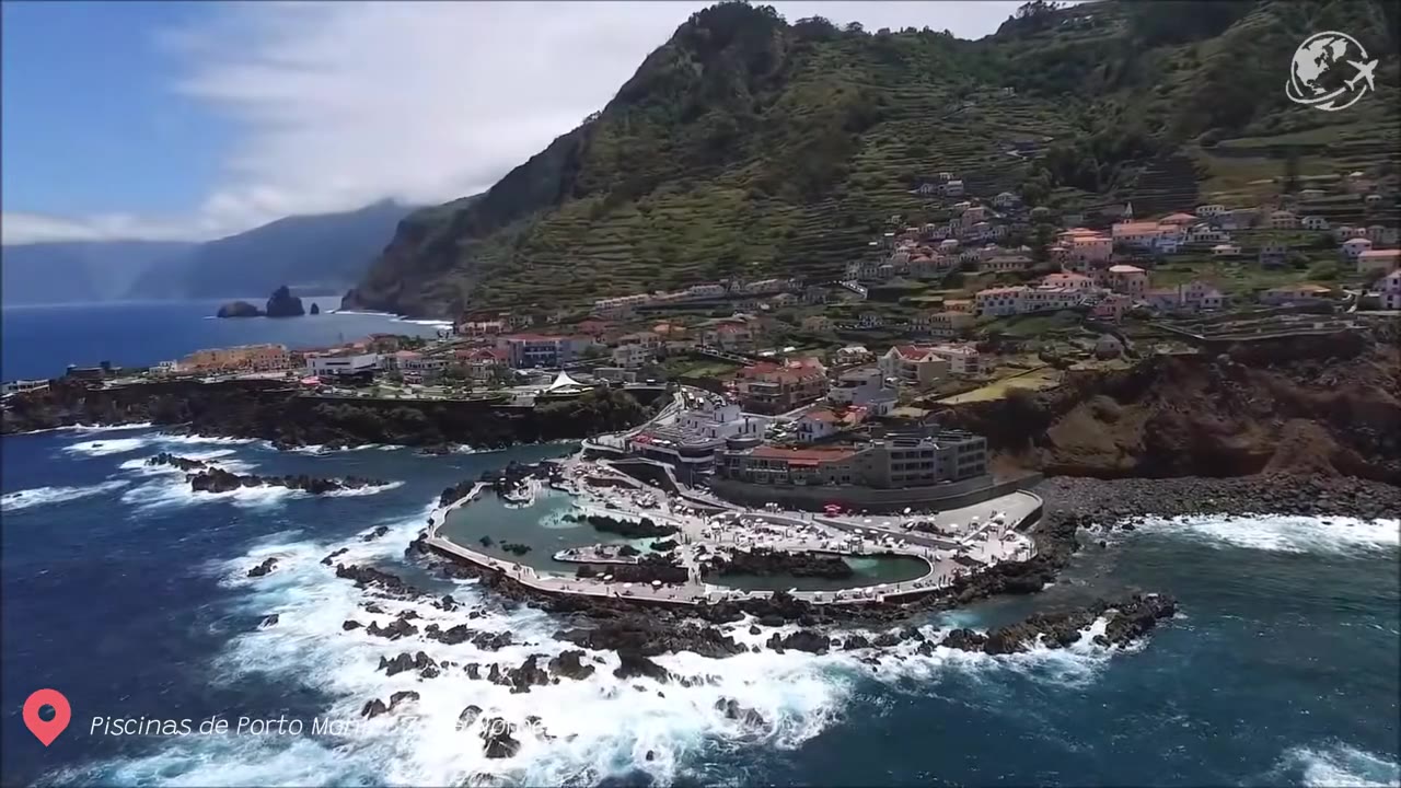 Volcanic black rock natural swimming pools filled with turquoise seawater at Porto Moniz, Madeira